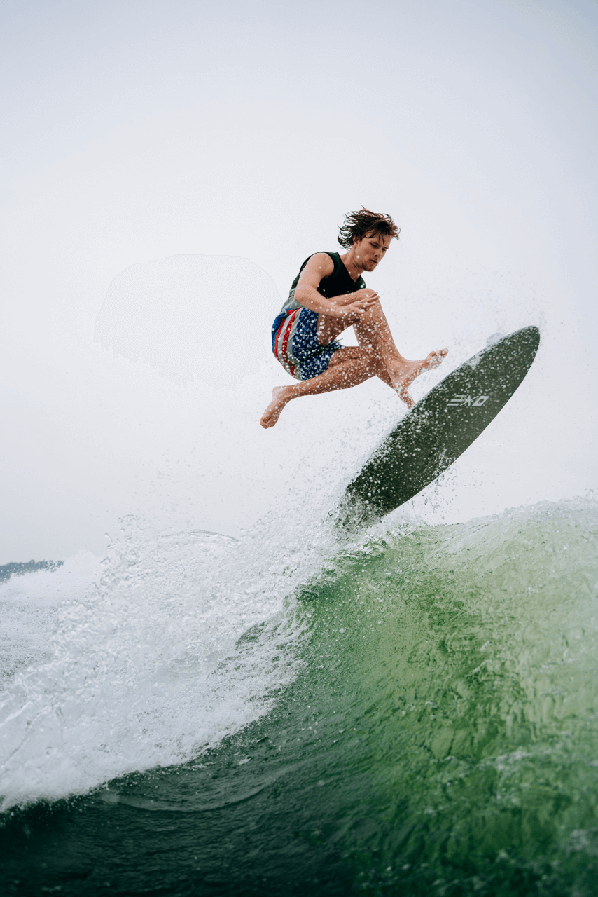 Man on surfboard riding a wave