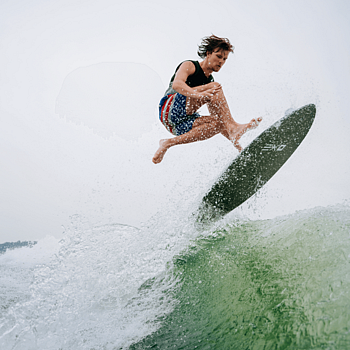 Man on surfboard riding a wave